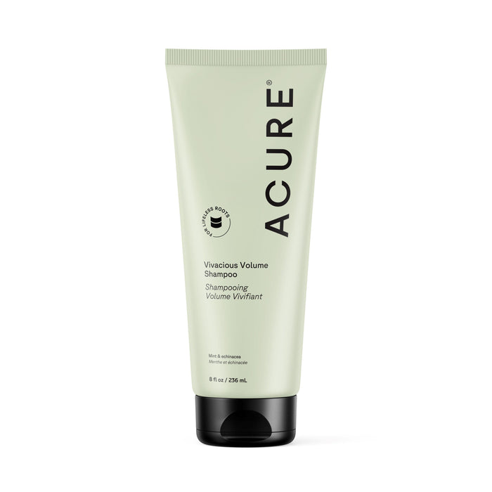 An 8 fl oz (236 ml) light green tube of Acure Vivacious Volume Shampoo, featuring black text and cap, with peppermint and moringa, stands upright on a white background.
