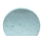 The VOESH Body Buffing Bar With AHA is a light blue, semi-circular exfoliator with dark specks, designed to smooth KP bumps. Shown against a white background.