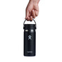 A hand holds a black Hydro Flask Wide Mouth Bottle with Flex Sip Lid, designed for coffee and tea, against a white background. Featuring the iconic logo near the base, the 16 oz bottle ensures hot drinks stay hot with its TempShield double-wall vacuum insulation.