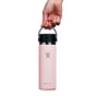 A hand holds a pink 20 oz Hydro Flask Wide Mouth Bottle with Flex Sip Lid™ against a white background, highlighting its sleek design and leakproof TempShield double-wall insulation.