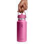 A hand holds a pink Hydro Flask Wide Mouth Bottle with a Flex Straw Cap, 32 oz. It features double-wall insulation, a logo on the front, and is set against a white background.