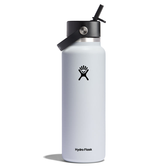 The Hydro Flask Wide Mouth Bottle with Flex Straw Cap, 40 oz, features a black Flex Straw Cap with a flexible straw and an attached carrying loop. The white bottle displays the Hydro Flask logo, a hand silhouette, and casts a shadow against a white background.