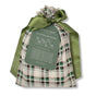 The Set of 10 Reusable Gift Bags - Tartan by Waste Free Celebrations features green, white, and black plaid fabric bags tied with green satin ribbons. A green tag lists the set contents and displays the Waste Free Celebrations brand.