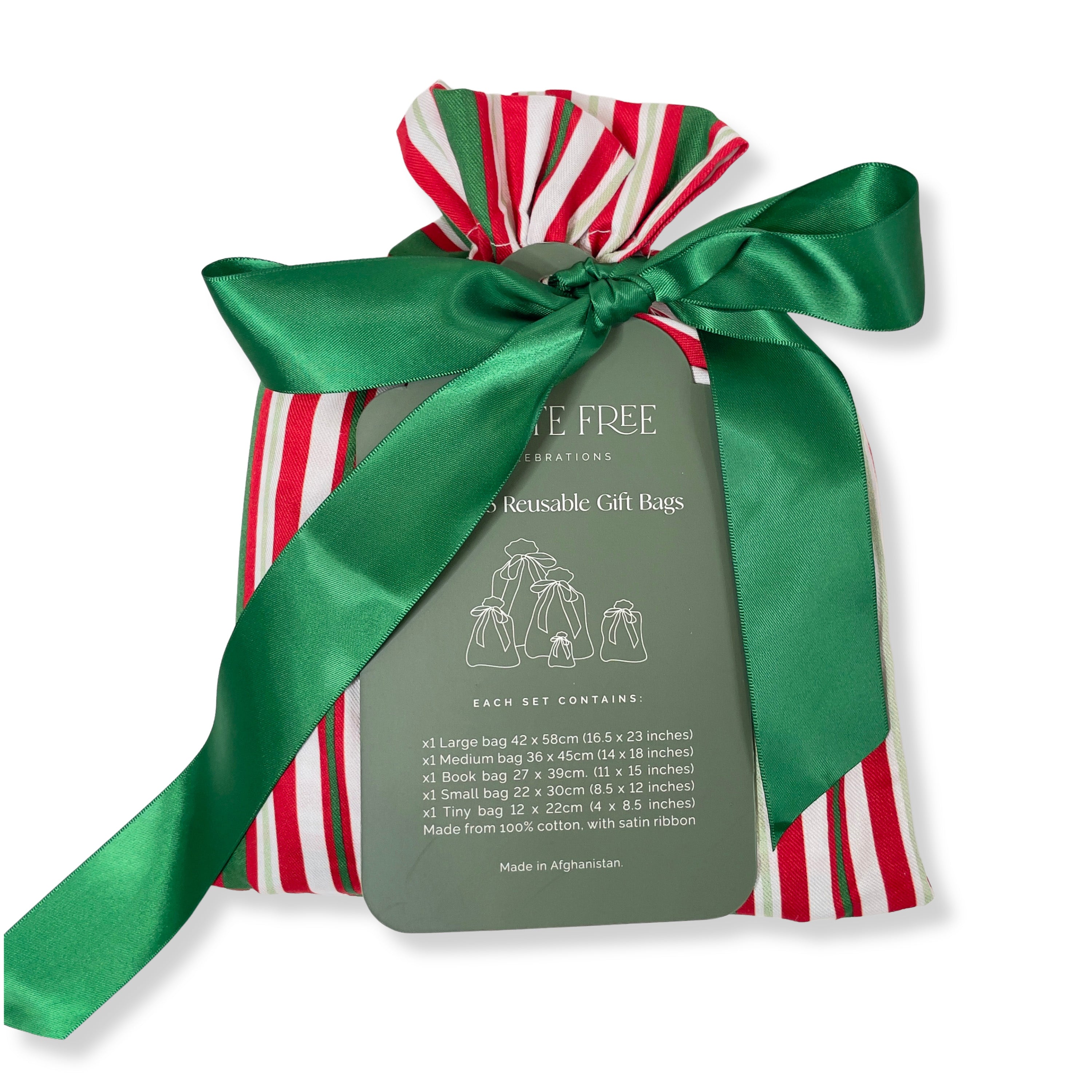 The Set of 5 Reusable Gift Bags - Traditional Stripes by Waste Free Celebrations features red, white, and green cotton bags with a green satin ribbon. A gray tag lists sizes and materials, offering a sustainable alternative to disposable wrap.