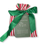 The Set of 5 Reusable Gift Bags - Traditional Stripes by Waste Free Celebrations features red, white, and green cotton bags with a green satin ribbon. A gray tag lists sizes and materials, offering a sustainable alternative to disposable wrap.