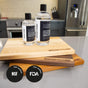 Three WoodForChef wooden cutting boards and two bottles of Food Grade Mineral Oil for Wood Cutting Board are shown on a kitchen counter, with NSF and FDA certification logos visible in the bottom left corner.
