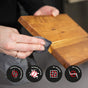A person wipes a wooden cutting board with WoodForChef Food Grade Mineral Oil. Four icons highlight benefits: odorless and food safe, prevents staining, no warping, and no cracking.