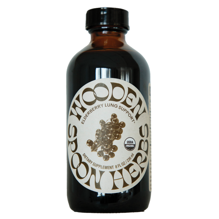 A brown glass bottle labeled Wooden Spoon Herbs Elderberry Lung Support Tonic features a USDA Organic seal. This 8 fl oz (236 mL) herbal syrup offers dietary supplement support for respiratory and immune health.