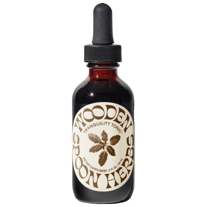 A brown glass dropper bottle labeled Wooden Spoon Herbs Tranquility Tonic, with a plant illustration, is displayed against a white background. This herbal supplement is formulated to help soothe the nervous system.