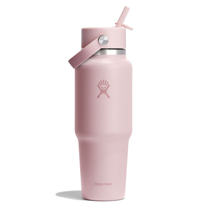 Against a plain white background, this tall pink Hydro Flask Wide Mouth Travel Bottle with Flex Straw Cap (32 oz) is perfect for hydration. It features a screw-on lid with flip straw, convenient carrying handle, and prominently displays the iconic Hydro Flask logo on its front.
