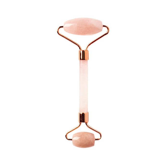 The WTHN Face Roller Kit features two smooth, oval rose quartz stones and rose gold accents, designed to reduce puffiness with a beauty technique inspired by Traditional Chinese Medicine.