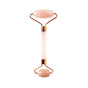 The WTHN Face Roller Kit features two smooth, oval rose quartz stones and rose gold accents, designed to reduce puffiness with a beauty technique inspired by Traditional Chinese Medicine.