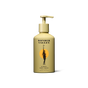 A yellow bottle of Wonder Valley Hinoki Body Wash with a pump, black text, and artwork of a person holding a branch before an orange circle, inspired by soothing hinoki and cedar wood scents.