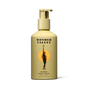 A beige bottle of Wonder Valley Hinoki Body Wash with a pump features a label showing a black silhouette of a woman holding an olive branch before an orange circle, reflecting its hinoki and cedar wood-inspired scent.