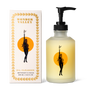 A bottle of Wonder Valley Facial Oil Cleanser with a pump stands beside its box, both showing a woman with flowing hair holding a branch in front of an orange circle and gold leaf border—a gentle cleanser for hydrated skin.