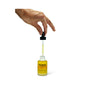 A hand holds a dropper with hyaluronic acid-infused Wonder Serum by Wonder Valley above its open yellow bottle, set against a white background.
