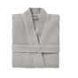 A neatly folded Coyuchi Unisex Organic Waffle Robe in light gray rests on a plain white background, showcasing its textured organic cotton fabric.