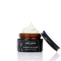 An open jar of Chagrin Valley Soap & Salve Whipped Squalane Face & Eye Mousee sits on a white background, its creamy mousse filling the jar. The black floral label is visible, with the lid placed next to the plant-powered moisturizer.