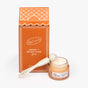 UpCircle Merry + Bright Eyes Gift Set features orange packaging, a jar of Eye Cream, and a cream-colored Eye Roller Massage Tool, all displayed on a white background.