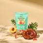A teal box of Plant People WonderCalm - Super Mushroom Gummies sits with a sliced peach, mushroom, red gummies, stones, and green leaves on a beige background—crafted for mood support and stress relief.