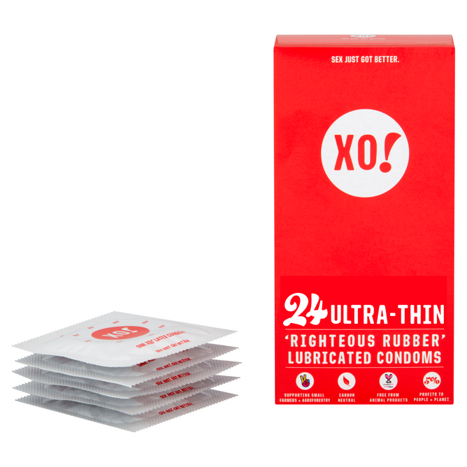 The red and white XO! Ultra-Thin Righteous Rubber Condoms box from Here We Flo contains 24 lubricated condoms crafted for a nearly naked feel, plus five individual packets. They emphasize reduced latex allergens, eco-friendly practices, and sustainably sourced rubber.