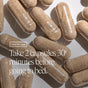 Several brown Ora Organic You're a Knockout Sleep & Stress Support Capsules are scattered on a light surface. Overlaid text reads: How to use—take 2 capsules 30 minutes before bed for natural sleep support.