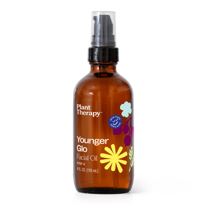A 4 fl oz (118 mL) amber bottle of Plant Therapy Younger Glo Facial Oil with a pump dispenser, decorated with floral graphics and white text on the front. This anti-aging facial oil is specially formulated to help reduce the appearance of fine lines and support youthful-looking skin.