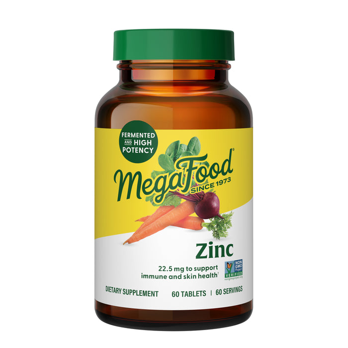 A bottle of MegaFood Zinc Tablets with a yellow label featuring vegetables, highlighting "Fermented" and "High Potency." Contains 60 tablets for immune, antioxidant, and skin health support.
