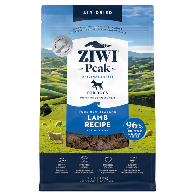 A blue and green bag of ZIWI Air-Dried Dog Food - Lamb, an all-natural, high-protein, grain-free recipe with superfoods. The packaging shows sheep grazing on green hills and promotes air-drying for a raw-alternative dog food.
