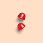 Two red dome-shaped Kids Zero Sugar Multi & Omegas Gummies floating against a light background.