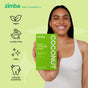 A smiling woman holds a green box of Zimba Whitening Strips. Icons on the left show these strips are vegan, cruelty-free, clean, and reduce sensitivity. A light green background emphasizes their teeth-whitening promise.