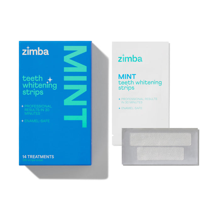 A blue Zimba Whitening Strips box, a white packet, and a clear tray with two strips are shown on a white background. The box highlights 14 treatments for fast, enamel-safe results and visibly whiter teeth.
