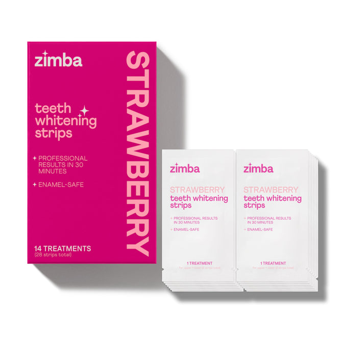 A bright pink Zimba Whitening Strips box, labeled for strawberry flavor, sits beside two white treatment packets. The box advertises 14 enamel-safe treatments and professional results in just 30 minutes.