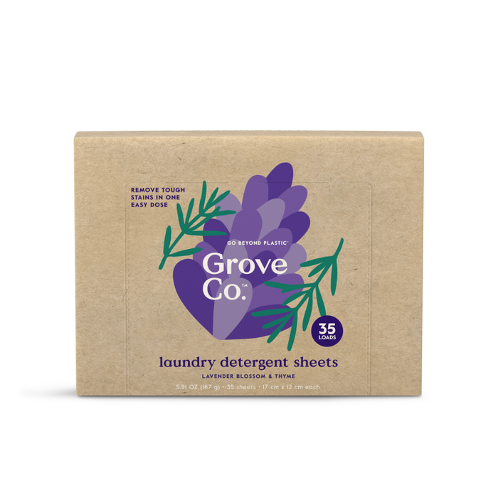 A box of Grove Co. laundry detergent sheets, featuring a purple leaf design with green sprigs, labeled “35 loads,” and “Lavender Blossom & Thyme.” The packaging is made from brown cardboard.
