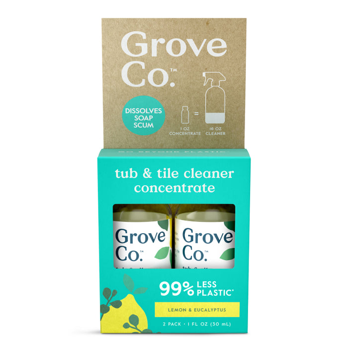 Front view of Grove Co. tub & tile cleaner concentrate packaging, featuring two bottles with lemon and eucalyptus scent. The box highlights 99% less plastic and dissolves soap scum.