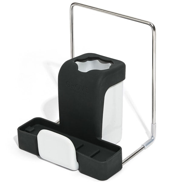 A modern black and white kitchen sink organizer with compartments for holding sponges and brushes, and a metal handle for easy carrying.