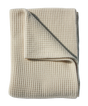 Cream-colored, folded Adult Popcorn Blanket - Cream in a textured waffle-knit pattern.