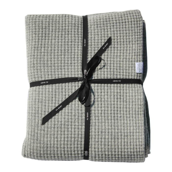 Moonstone Adult Popcorn Blanket in a gray temperature-regulating waffle-knit texture, folded and tied with a black ribbon.