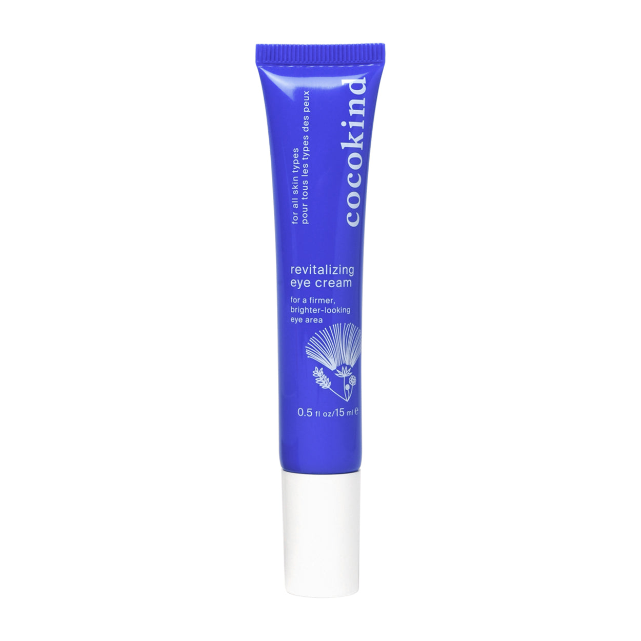 A 0.5 fl oz blue tube of Cocokind Revitalizing Eye Cream, with a white cap and text plus a floral graphic, targets dark circles and wrinkles around the delicate eye area.