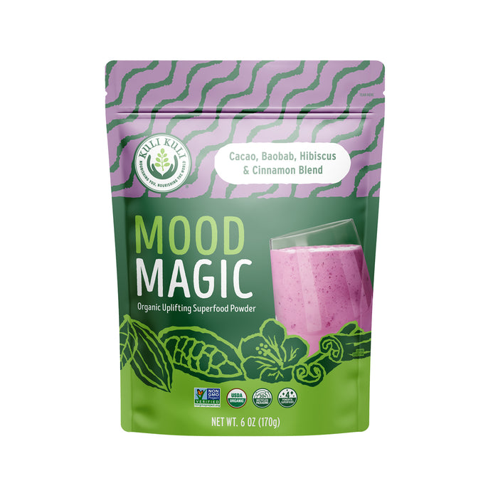 A colorful pouch of Mood Magic organic uplifting superfood powder by Kuli Kuli, featuring a pink smoothie image and labeled as a cacao, baobab, hibiscus, and cinnamon blend; 6 oz (170g) package.