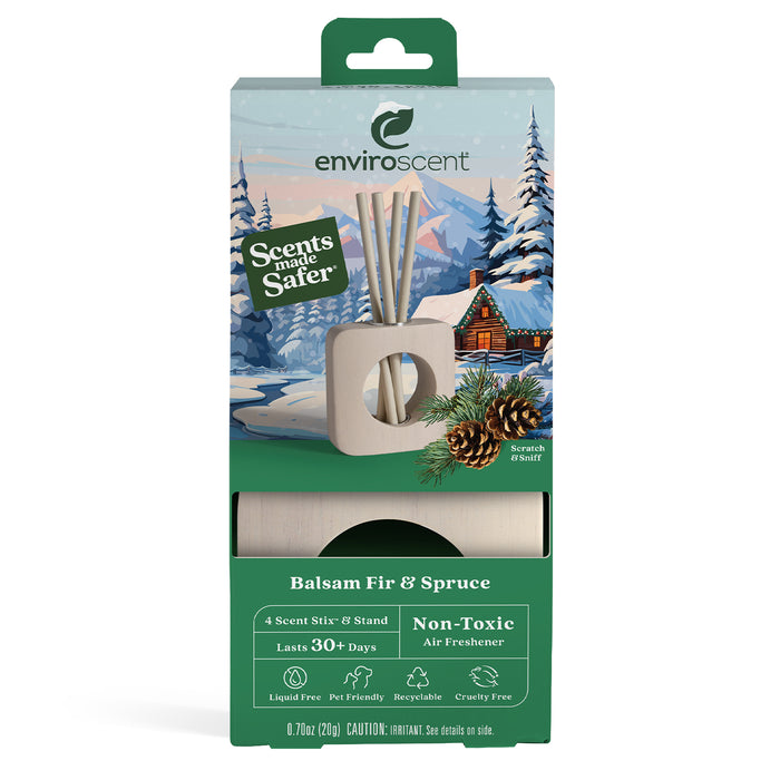 A box of Enviroscent Balsam Fir & Spruce non-toxic air freshener with a winter cabin scene, pinecones, and a wood scent stick holder shown on the packaging. Text highlights 30+ day use, recyclable, and cruelty-free.