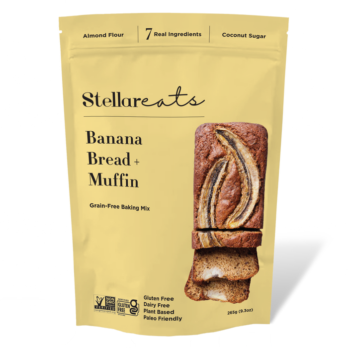A yellow pouch of Stellareats Banana Bread + Muffin grain-free baking mix, featuring images of banana bread slices and labels for gluten-free, dairy-free, plant-based, and paleo-friendly attributes.