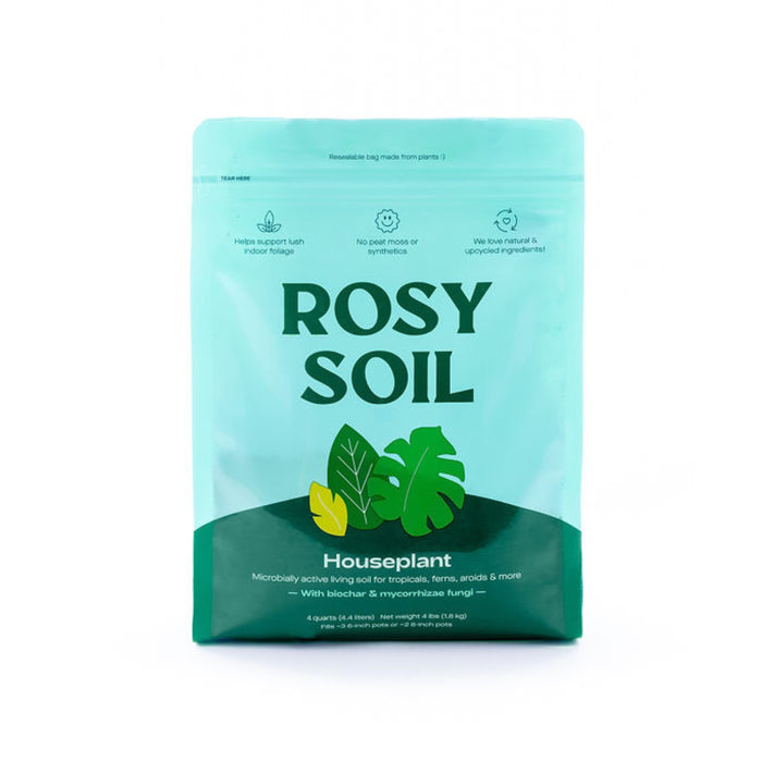 A teal resealable bag labeled Rosy Soil Houseplant, featuring leaf illustrations and icons for plant support, pets and kid safety, and upcycled ingredients. The bag contains soil for houseplants.