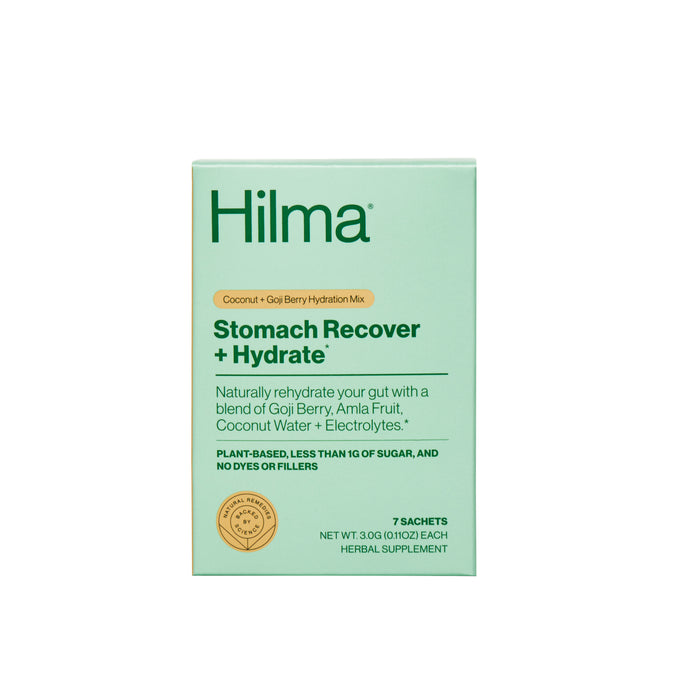 A green box of Hilma Stomach Recover + Hydrate supplement, featuring details about coconut and goji berry hydration mix, plant-based ingredients, and 7 sachets included.