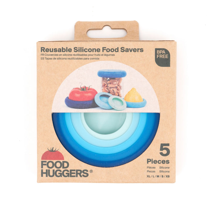 Cardboard packaging for Food Huggers reusable silicone food savers, showing five colorful silicone lids in various sizes. The packaging displays images of the lids and some fruit they can cover. BPA free.