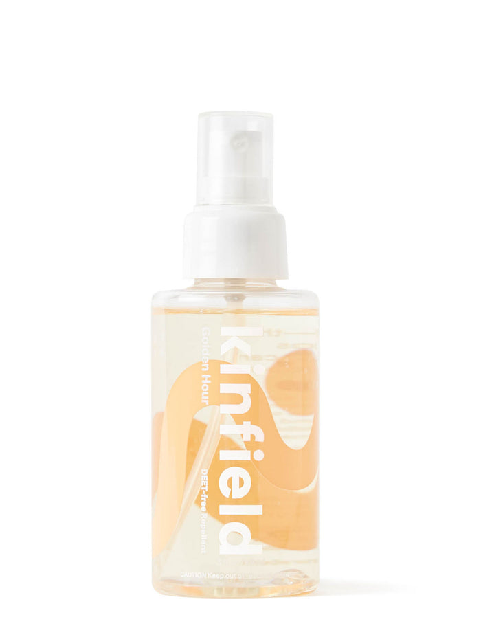 A clear spray bottle labeled Kinfield Golden Hour with a white pump and cap, containing a light yellow liquid, set against a plain white background.