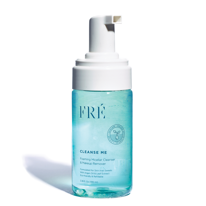 A clear bottle of FRÉ Cleanse Me Foaming Micellar Cleanser & Makeup Remover with a white pump dispenser. The blue liquid inside is visible, and the label includes product details and a small plant icon.