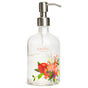 The Refillable Gel Hand Soap Dispenser by Grove Co. is a clear, sustainable glass dispenser with a metal pump featuring a floral and fruit pattern, including pomegranates. Grove Collaborative is elegantly printed above the design on this recyclable, refillable product.