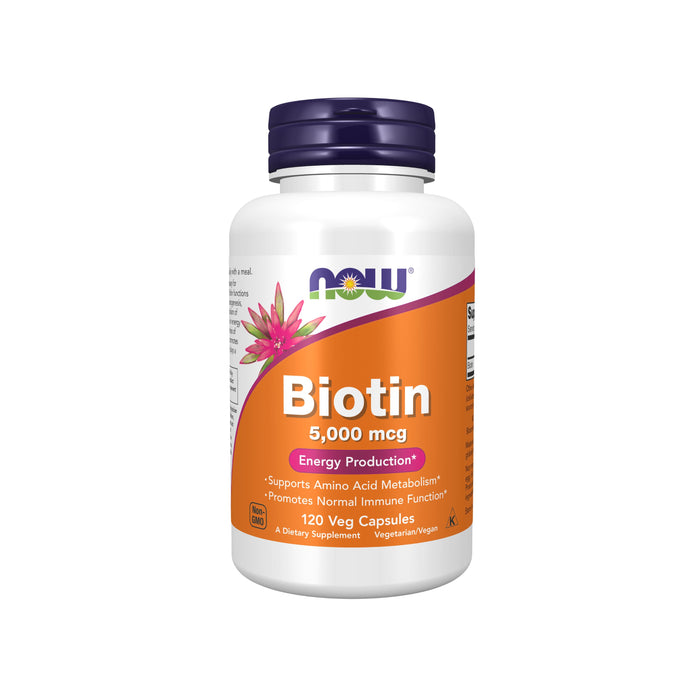 A white bottle of NOW brand Biotin 5,000 mcg dietary supplement with a purple cap and orange label, featuring a pink flower and text highlighting energy production and immune support. Contains 120 vegetarian capsules.