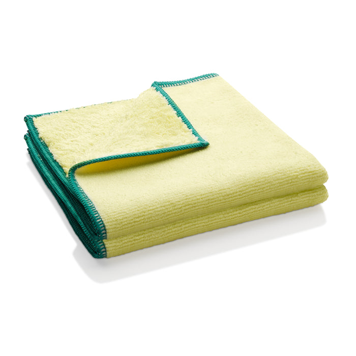 A folded yellow microfiber cloth with green stitched edges, showing a corner flipped over to display the soft, textured surface on both sides.